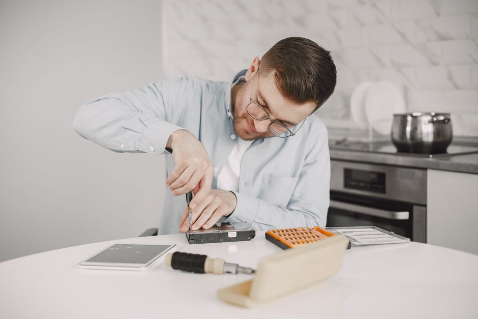 Appliance repair technician at work